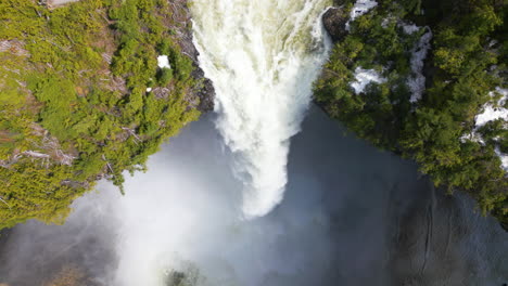 Aerial-birdseye-descending-along-Helmcken-Falls-water-flow,-Canada