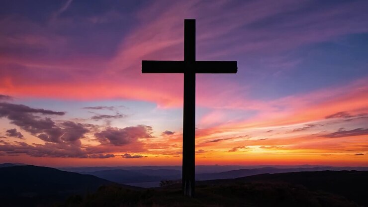 Cross on Mountain at Sunset