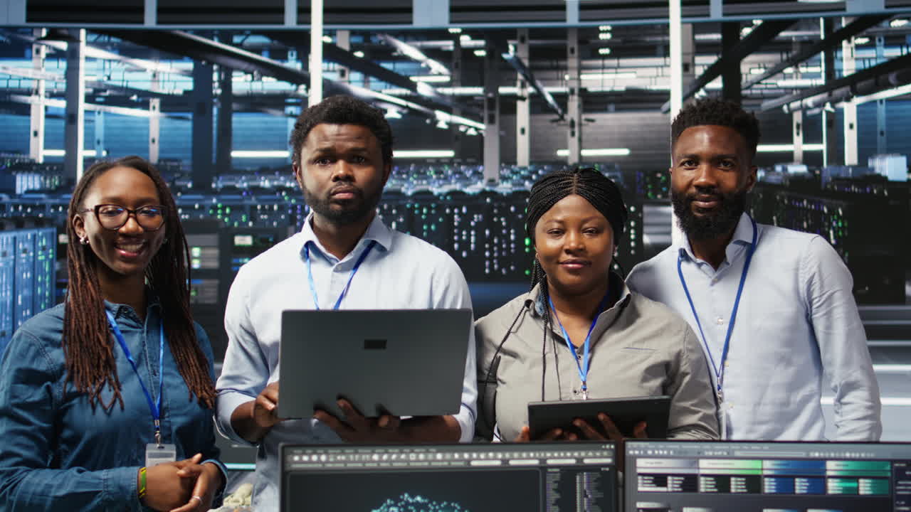 Portrait of smiling data center technicians analyze issues using node tree tool