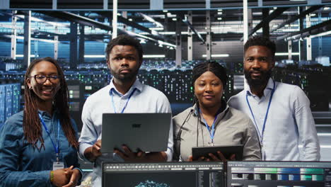 portrait of smiling data center technicians analyze issues using node tree tool