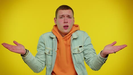 puzzled clueless teen student boy raising hands in helpless gesture, confused by difficult question