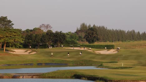 a tranquil golf course with players and water features