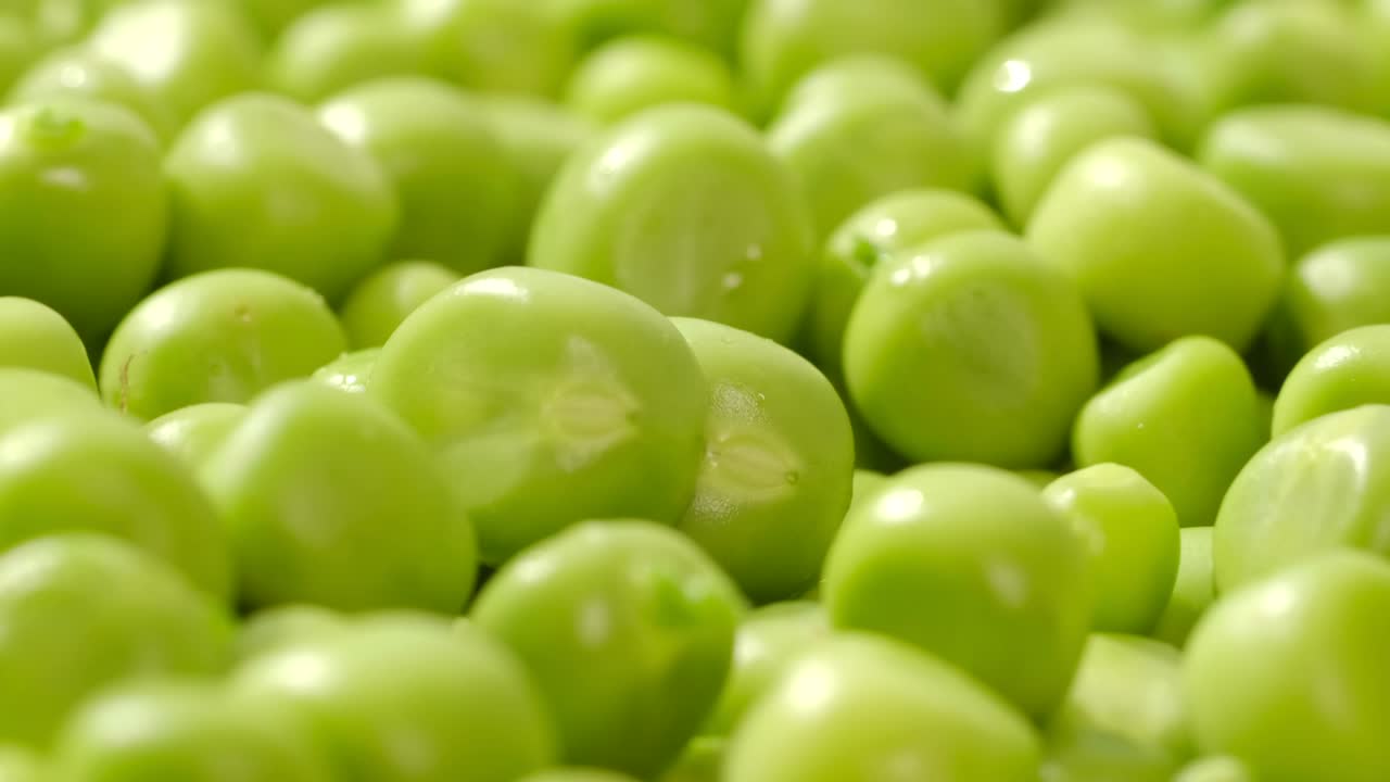 Fresh green peas rotate. Close up.