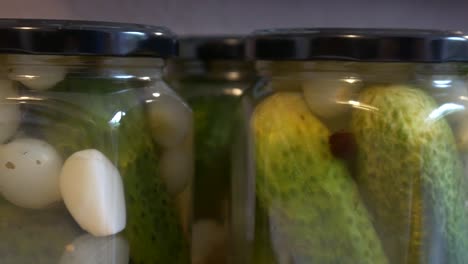 sliding shot of pickled cucumbers in glasses