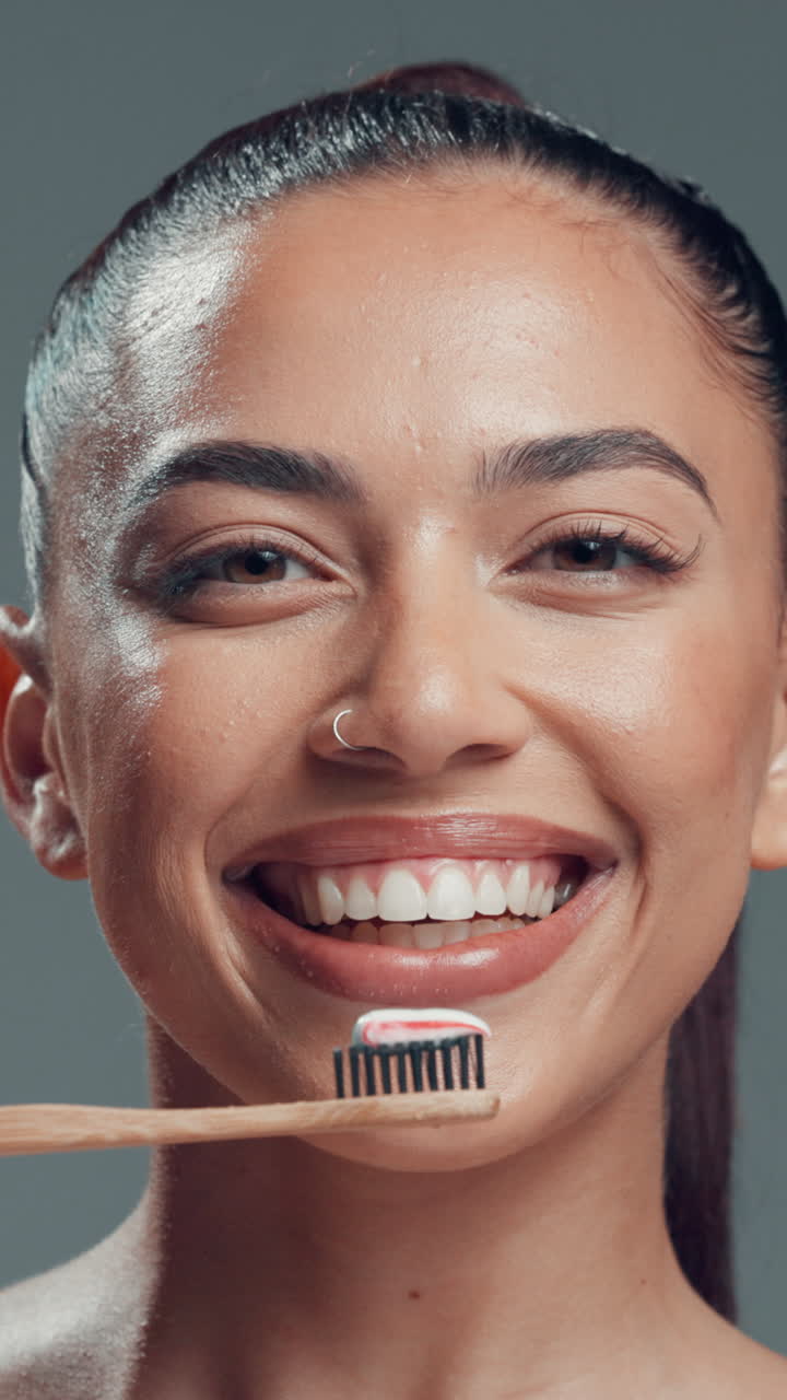 Young Woman Smiling with Toothbrush and Toothpaste