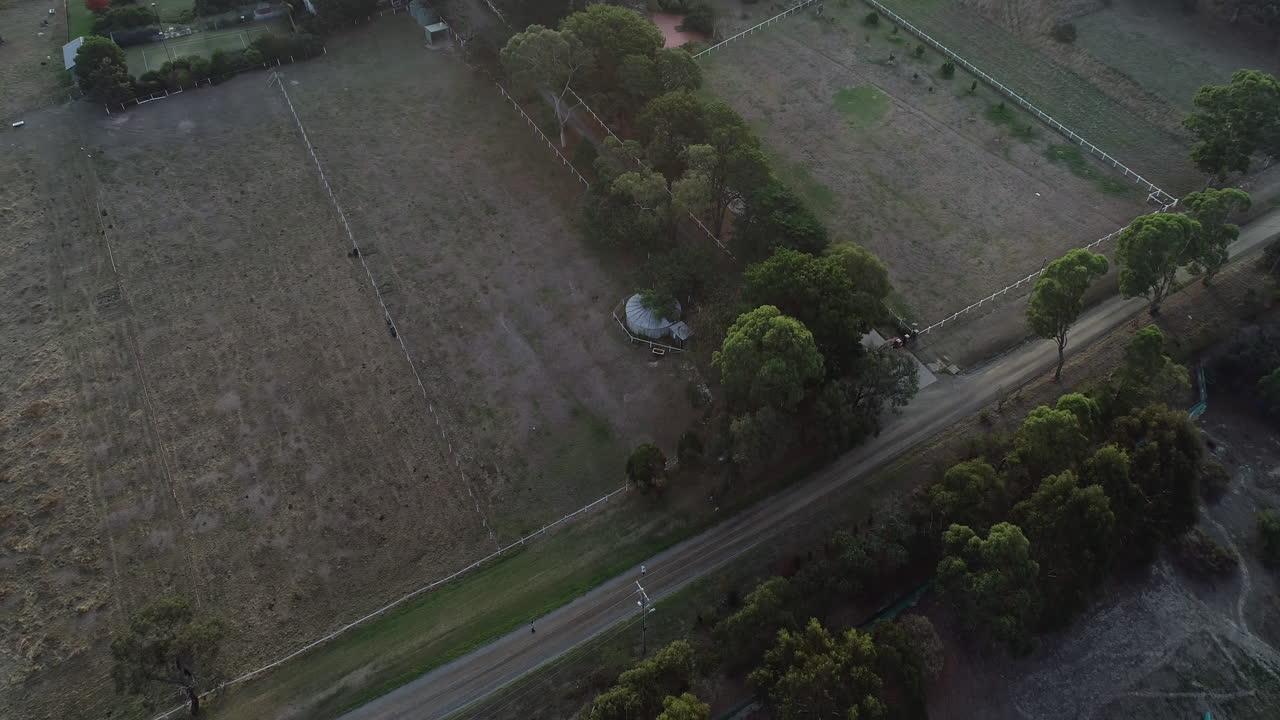 Smooth aerial fly over and bomb shot over farming agricultural landscape below.