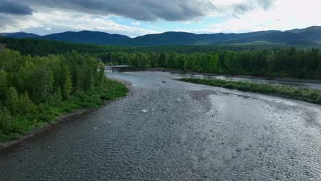 rafters on flathead river with rocky riverbed near glacier national park in montana, usa