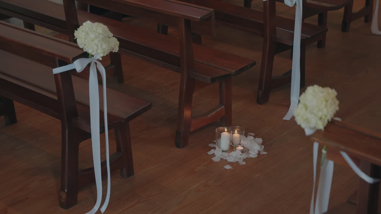 Romantic wedding aisle with flowers candles and petals