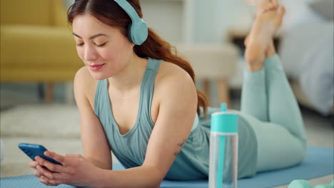 smartphone, yoga and headphones of woman typing