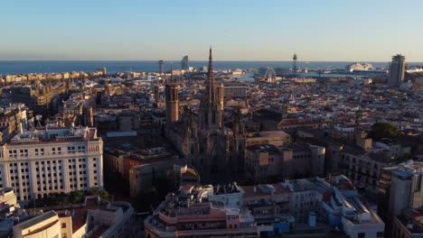 barcelona cathedral in middle of the city at dawn. aerial rotation