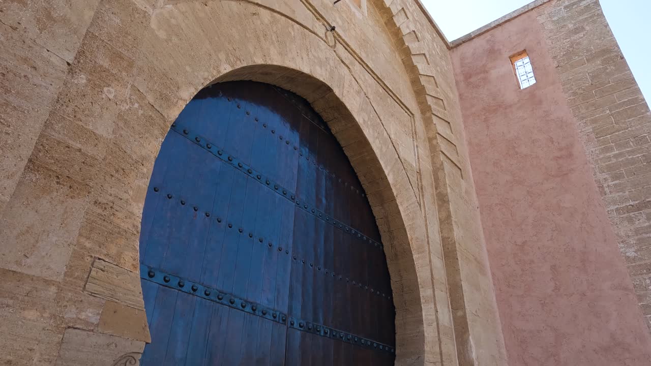 Tilt down along Bab Laalou large wooden keystone gate in Rabat Morocco