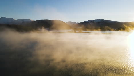 seaside city with mountain silhouettes during foggy sunset in molde, norway. - wide shot