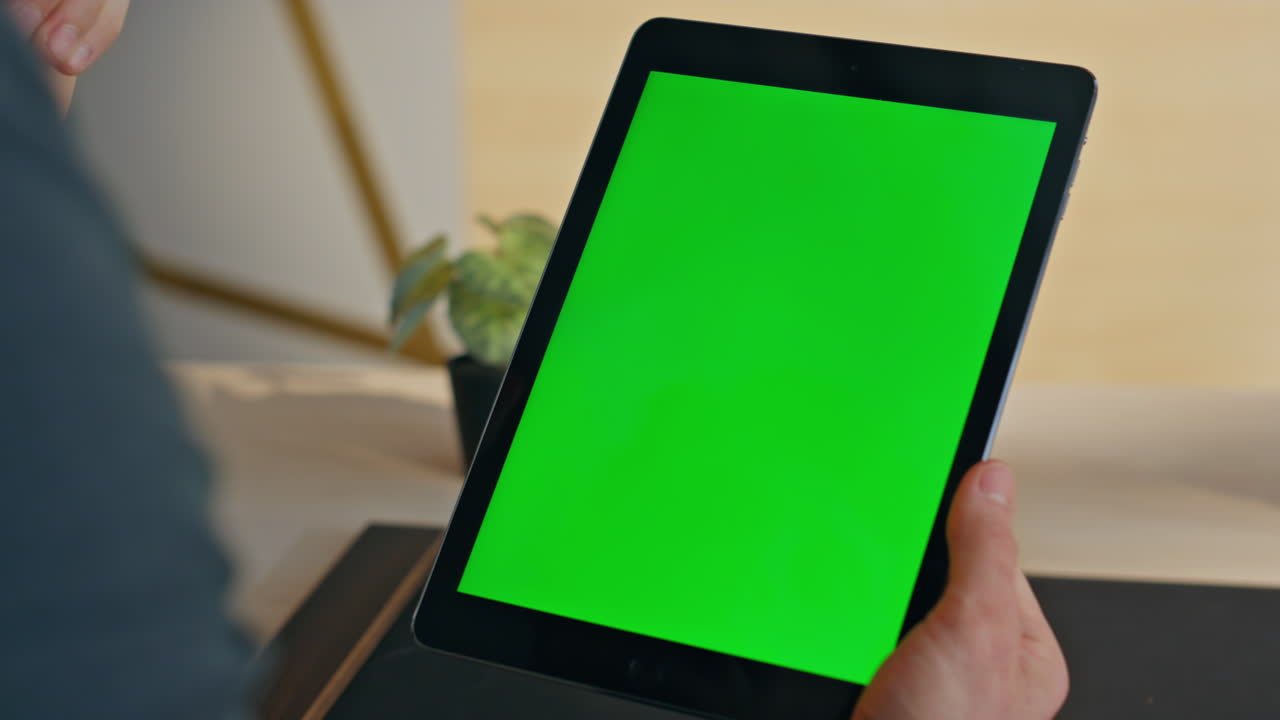 Man finger touching greenscreen tablet workplace closeup. Manager hand swiping