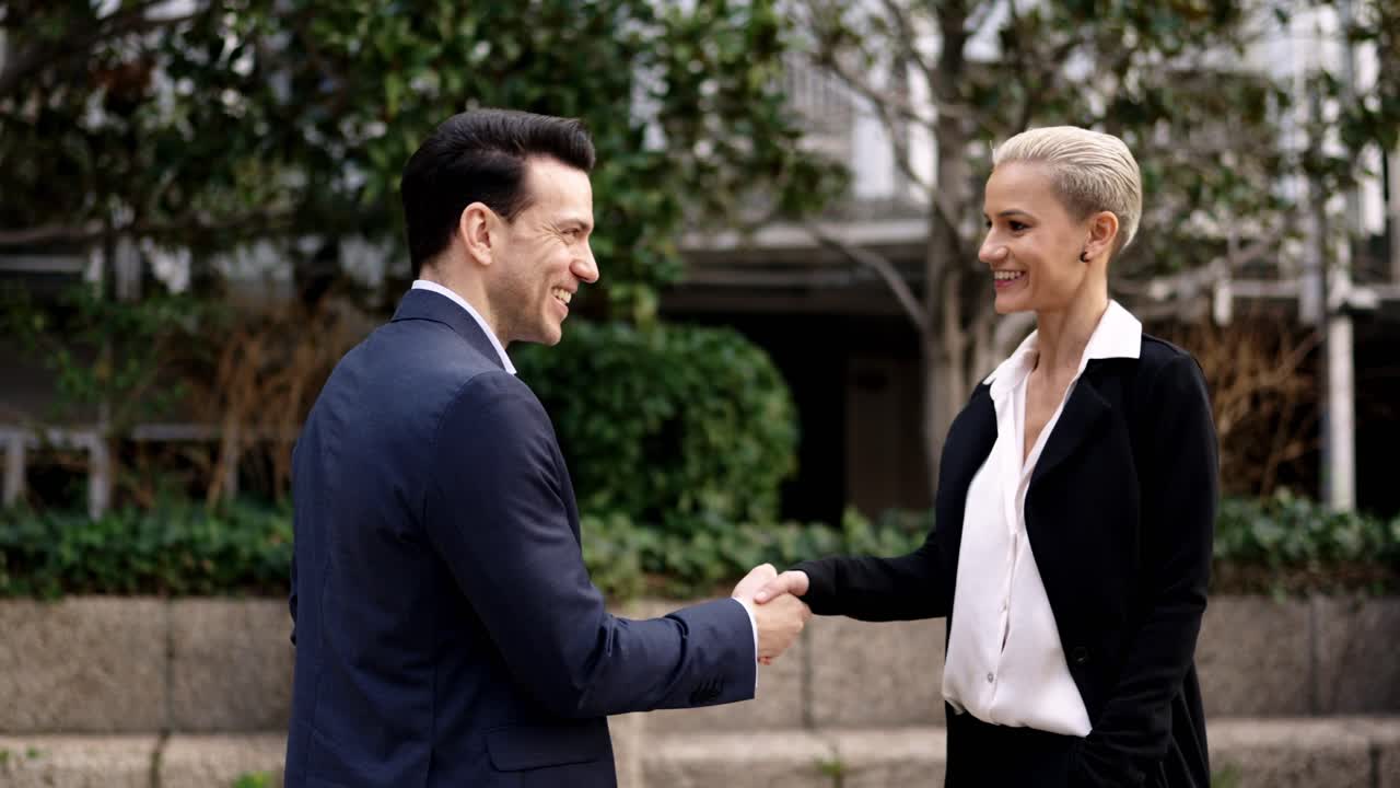 Business handshake between a man and a woman