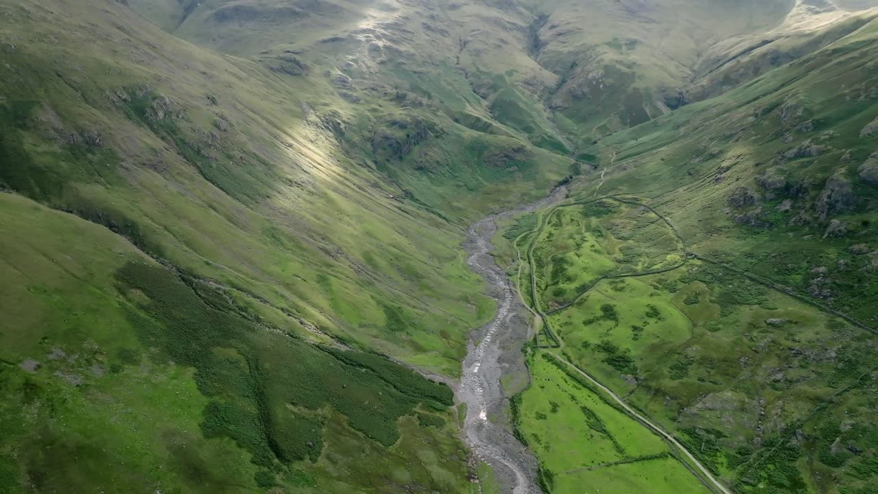 Deep Green Valley With Winding Stream And Pools Of Summer Sunshine. Crinkle Crags, Great Langdale, Lake District, Cumbria, UK
