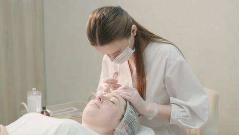 cosmetologist performing facial injection procedure