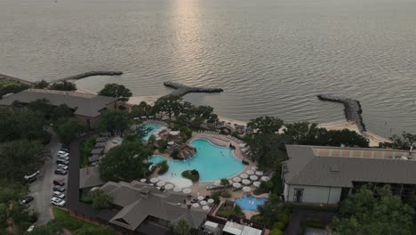 aerial reveal of sunsetting over mobile bay near point clean, alabama