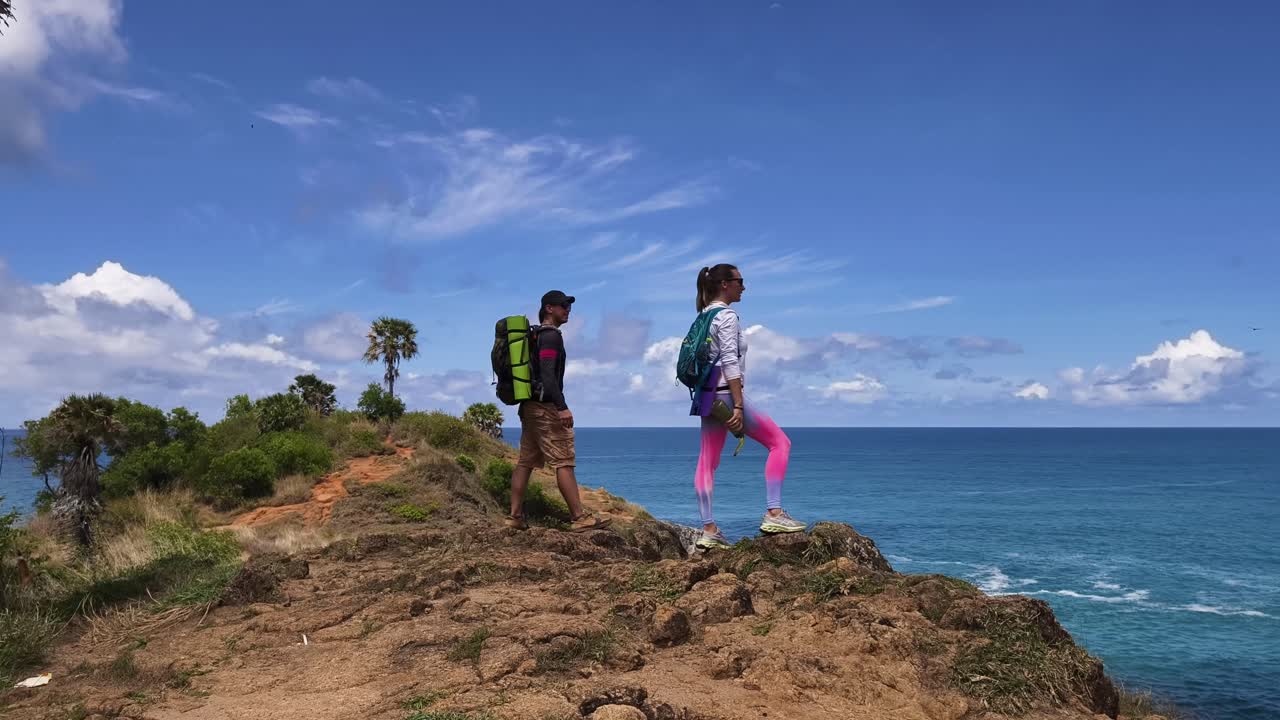 Couple Hiking on Coastal Cliff with Ocean View