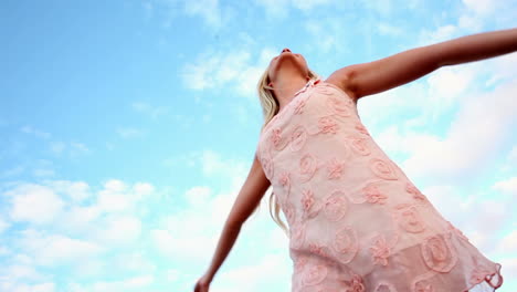 blonde woman spinning joyfully