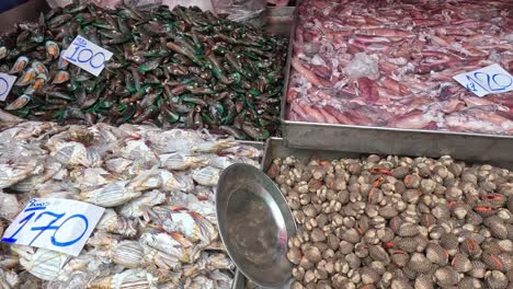 various seafood displayed with price tags