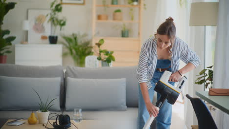 smiling woman vacuuming floor