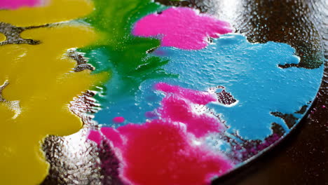 colorful paint splashes on a wooden surface