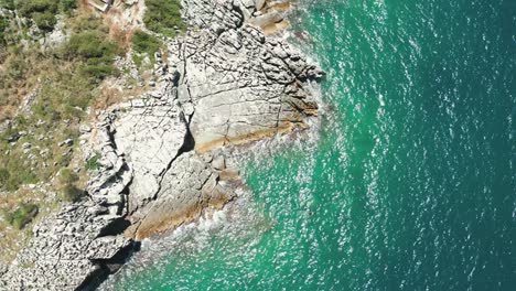 albania, blue waters of the ionian sea and rocky cliffs along the shore