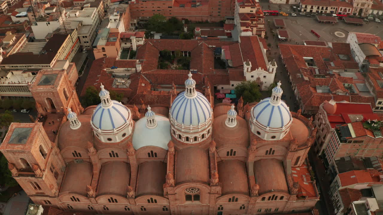 Stunning panoramic view of the historic center of Cuenca, Ecuador, with a focus on the majestic blue domes of the Cathedral of the Immaculate Conception.