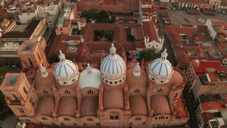stunning panoramic view of the historic center of cuenca, ecuador, with a focus on the majestic blue domes of the cathedral of the immaculate conception.