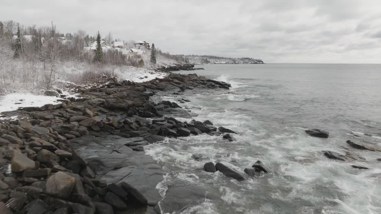 Waves Crashing Ashore On Lake Superior In Winter In Minnesota, USA. - aerial shot