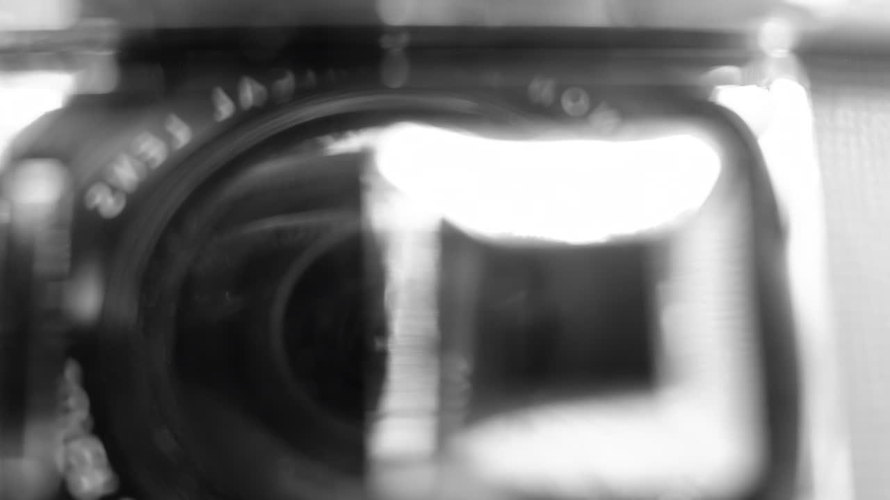 Close up of a camera lens in black and white