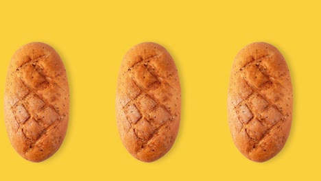 seamless animation of a whole diet loaf of bread top view above a yellow background, copy space