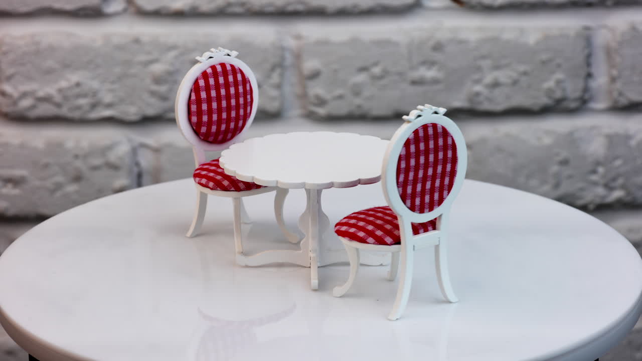 Adorable little white round table with two chairs on sides. Beautiful toy furniture at the rotating table.