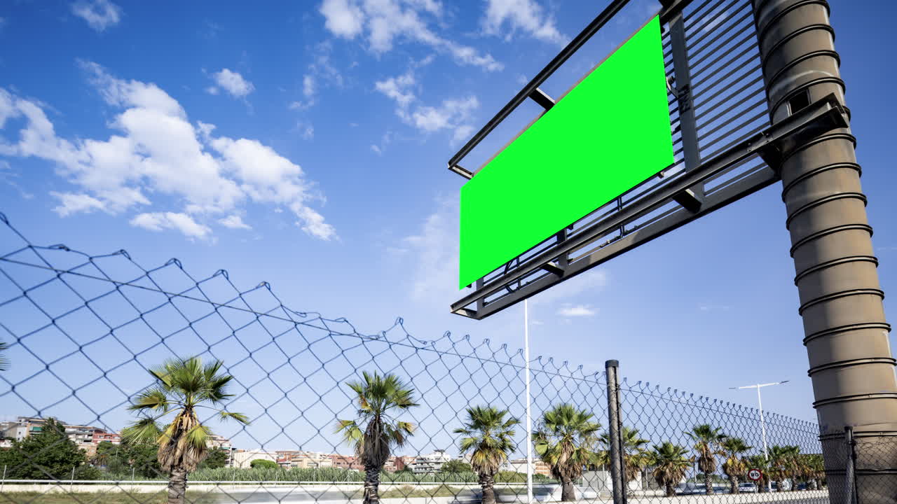 Rush of traffic on highway in city with green screen on the overhead video