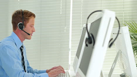 Businessman-having-a-phone-call-with-headset-in-call-center