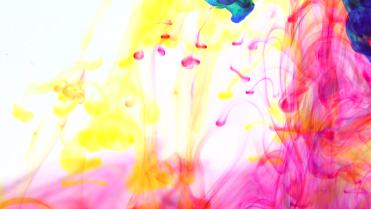 Beautiful neon ink mixing slowly together