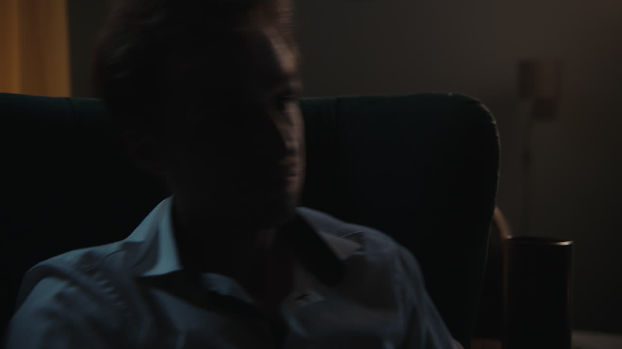 Man Sitting in Chair at Night