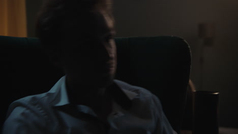 man sitting in chair at night