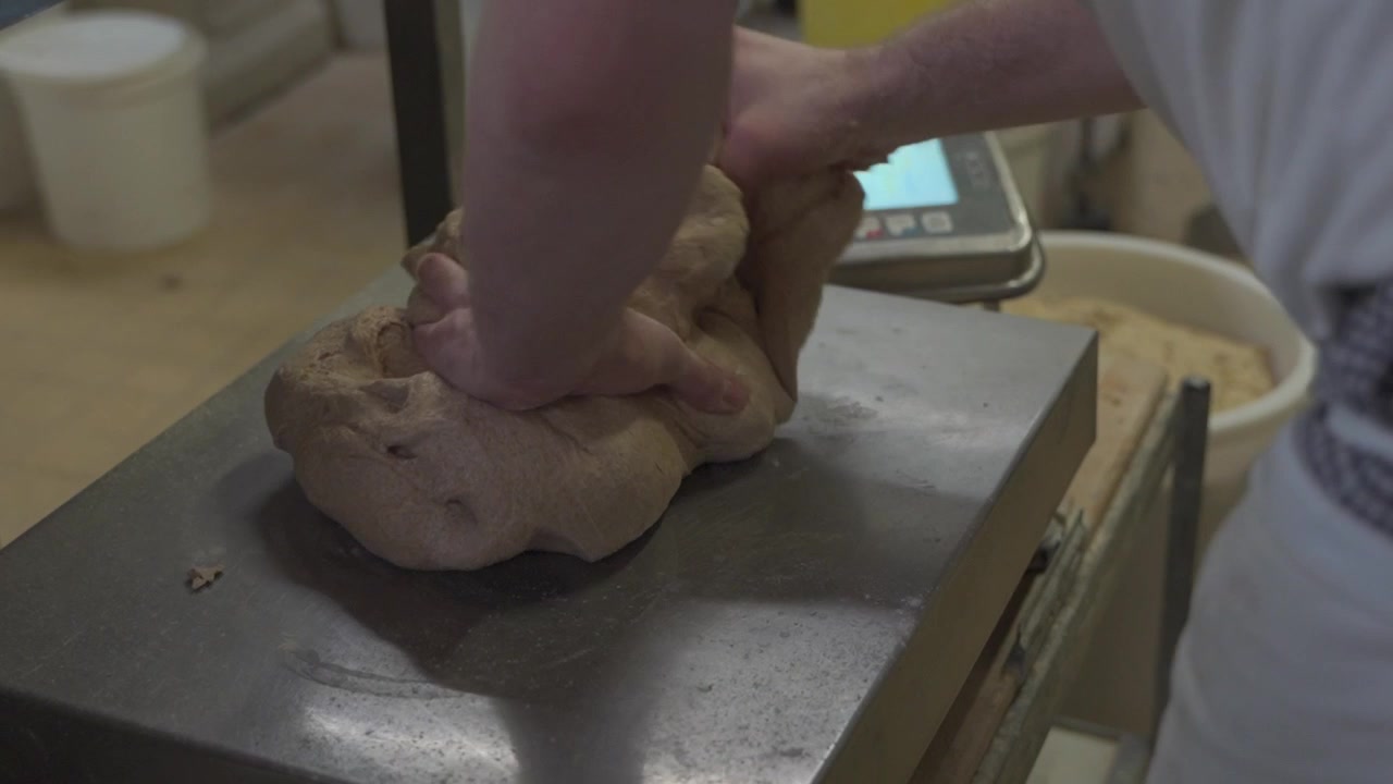large amount of dough is weighed in a bakery for baking bread