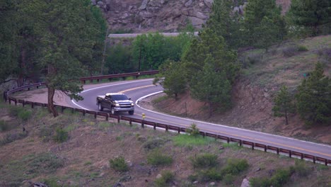 Aerial-view-of-truck-going-through-a-tight-curve-in-the-mountains