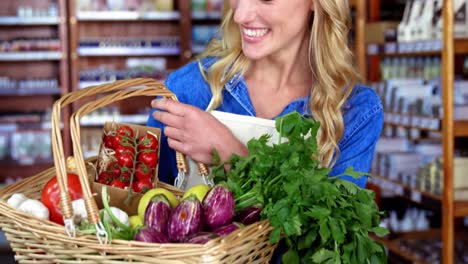 Personal-Femenino-Sonriente-Sosteniendo-Una-Canasta-De-Verduras-En-La-Sección-Orgánica