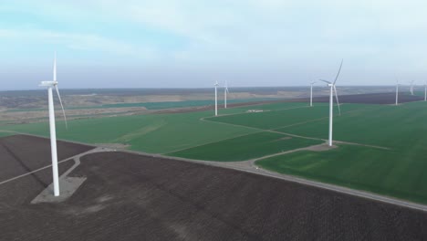 Green-Power-Production-Farm-on-Overcast-Day,-Aerial-Static-Drone-View