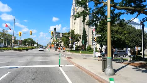 car pov: ottawa city street with historic church and traffic signals