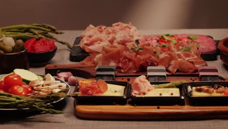 italian or spanish restaurant with traditional tapas food, spanish cuisine, delicious tapas and cheese plate, bruschetta with cheese, olives dry tomatoes and tasty sandwich bar appetizer, buffet