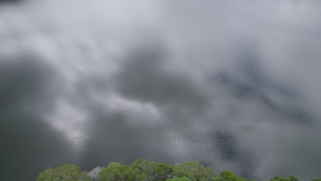 Cloudy-Sky-Reflected-In-Lake-Morris-In-Cairns,-North-Queensland,-Australia---drone-shot