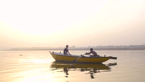 boat being rowed down river ganges