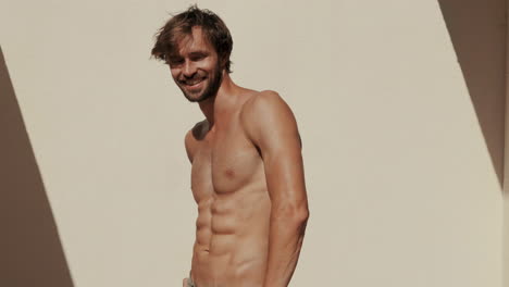 smiling man with muscles posing outdoors