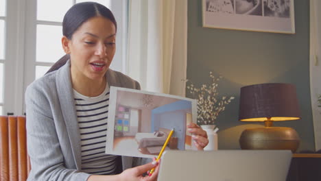 female architect or interior designer working from home having meeting via video call