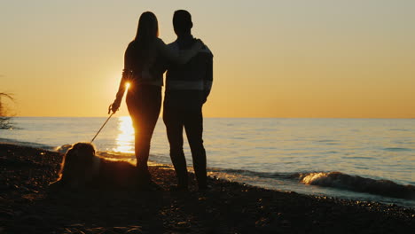 Couple-With-Dog-Watch-the-Sunset