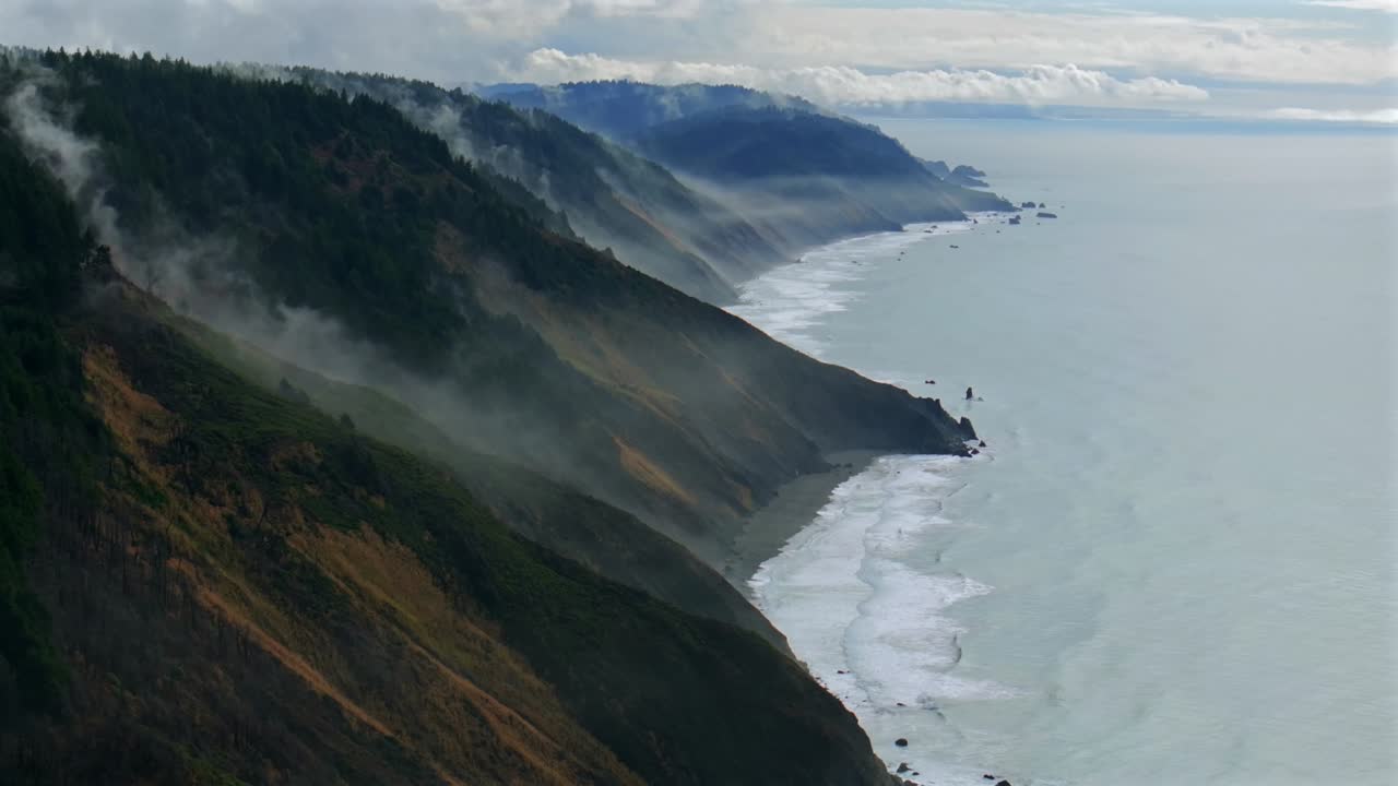 USAL Beach Sinkyone Wilderness Northern California aerial drone rugged untouched coastline mist rain evaporating morning remote untouched black sand waves crashing bluffs Lost Coast Trail forward pan